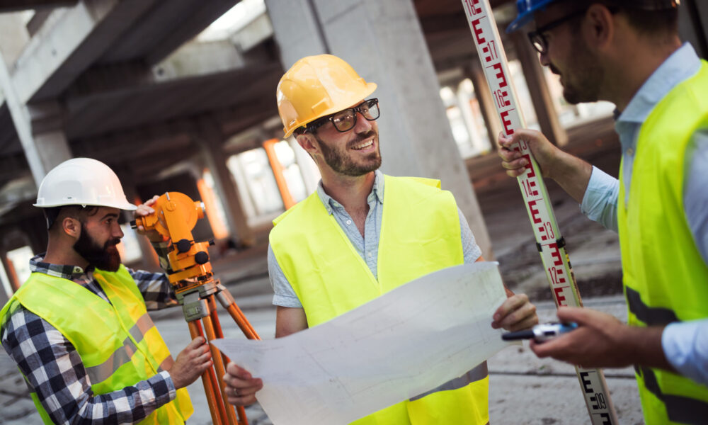 Portrait of construction engineers working on building site together